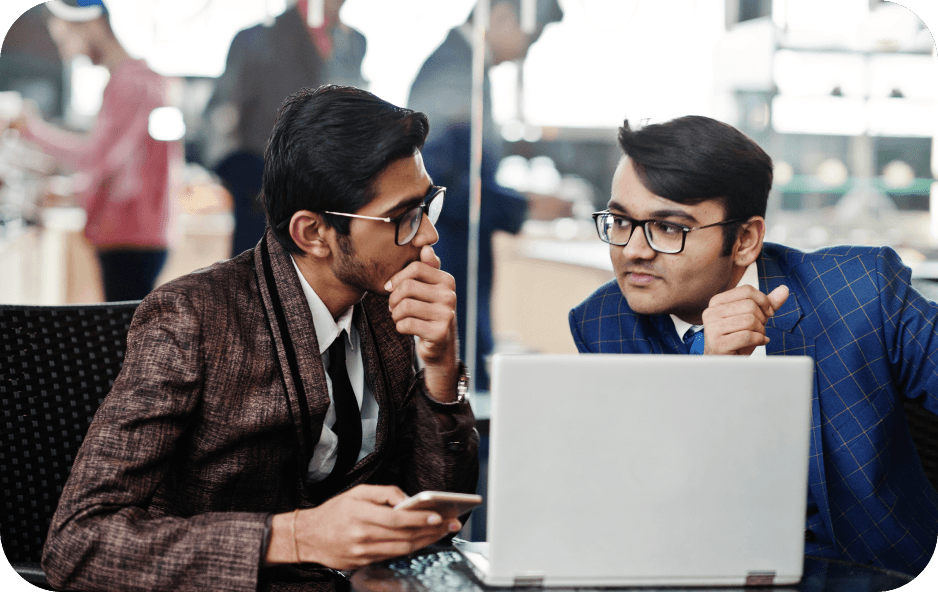Two professionals discussing work at a laptop
